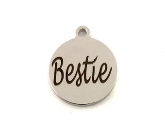 May include: Silver charm with the word "Bestie" engraved in a cursive font.