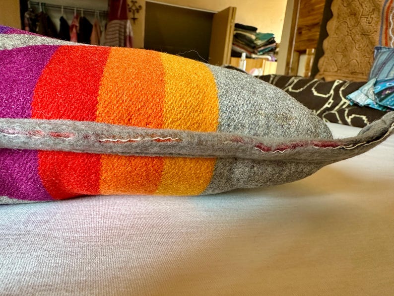 May include: A white ceramic mug with a black handle and the text "But First, Coffee" in a black, bold font. The mug is on a wooden surface. The mug is 10 cm tall.