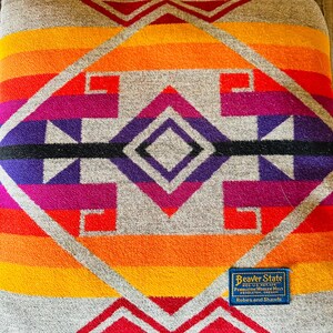 May include: A white ceramic mug with a black handle and the text "But First, Coffee" in a black, bold font. The mug is on a white surface.