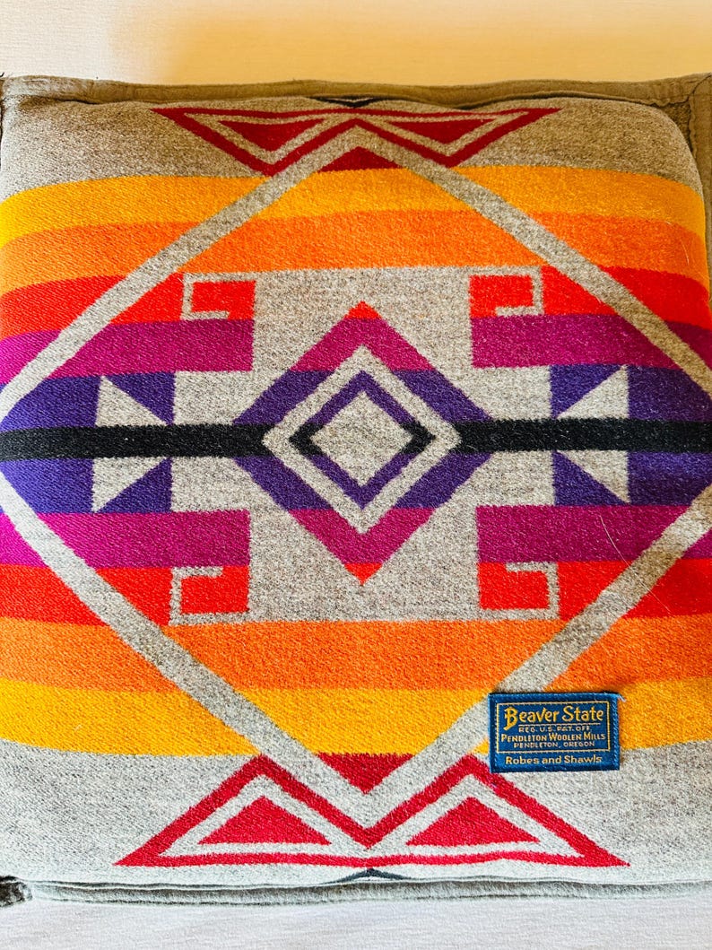 May include: A white ceramic mug with a black handle and the text "But First, Coffee" in a black, bold font. The mug is on a white surface.