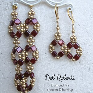 May include: A pair of long earrings and a pair of shorter earrings made with red and gold beads. The earrings are hanging from a white stand. The text "Deb Roberti Diamond Tila Bracelet & Earrings" is printed below the earrings.