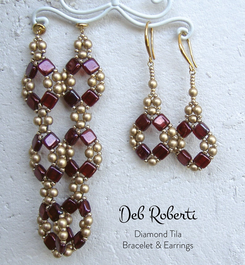 May include: A pair of long earrings and a pair of shorter earrings made with red and gold beads. The earrings are hanging from a white stand. The text "Deb Roberti Diamond Tila Bracelet & Earrings" is printed below the earrings.