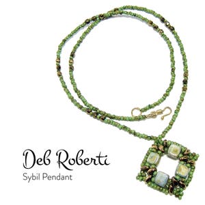 May include: A green and bronze beaded necklace with a square pendant featuring green and bronze beads. The pendant has a square opening in the center. The necklace is labeled "Deb Roberti Sybil Pendant".
