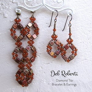 May include: A pair of long, brown and orange beaded earrings with a diamond shape design, and a pair of shorter earrings with the same design. The earrings are hanging on a white stand. The text "Deb Roberti" and "Diamond Tila Bracelet & Earrings" is below the earrings.