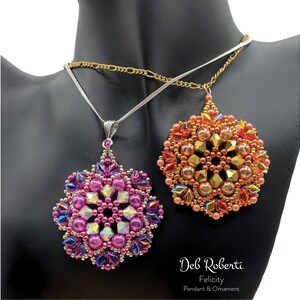 May include: Two beaded necklaces with intricate floral pendant designs. The pink pendant has iridescent beads and the orange pendant has gold beads. The necklaces are on a mannequin's neck. The text "Deb Roberti Felicity Pendant & Ornament" is at the bottom of the image.