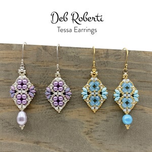 May include: Three pairs of beaded earrings with a diamond shape design. The earrings are silver, gold, and silver with a pearl drop. The earrings are displayed on a wooden surface. Deb Roberti Tessa Earrings.