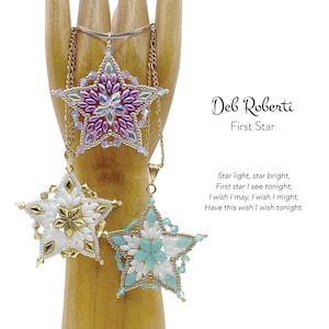 May include: Three star-shaped beaded pendants in purple, white, and turquoise, each suspended from a gold chain. The pendants are intricately detailed with various bead sizes and colors. Text on the right reads "Deb Roberti First Star".