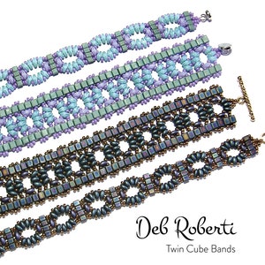 May include: Four beaded bracelets in different colours and patterns, including teal, purple, and brown. The bracelets are made with small, square beads and feature a repeating geometric design. The bracelets are labelled "Deb Roberti Twin Cube Bands".