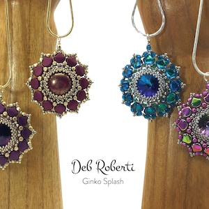 May include: Three beaded necklaces with different coloured pendants. The pendants are all round and have a starburst design. The necklaces are on wooden display stands. The text "Deb Roberti Ginko Splash" is below the necklaces.