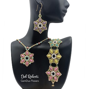 May include: A jewelry set featuring a necklace, earrings, and bracelet, all adorned with beaded floral designs. The set includes pink, green, yellow, and purple beads, with gold-colored metal accents. The text "Deb Roberti GemDuo Flowers" is visible.