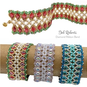 May include: Three beaded bracelets in red, white, and blue, with gold accents. The bracelets are made with small beads and gemstones, and are arranged on a wooden dowel. The text "Deb Roberti Diamond Ribbon Band" is also visible.