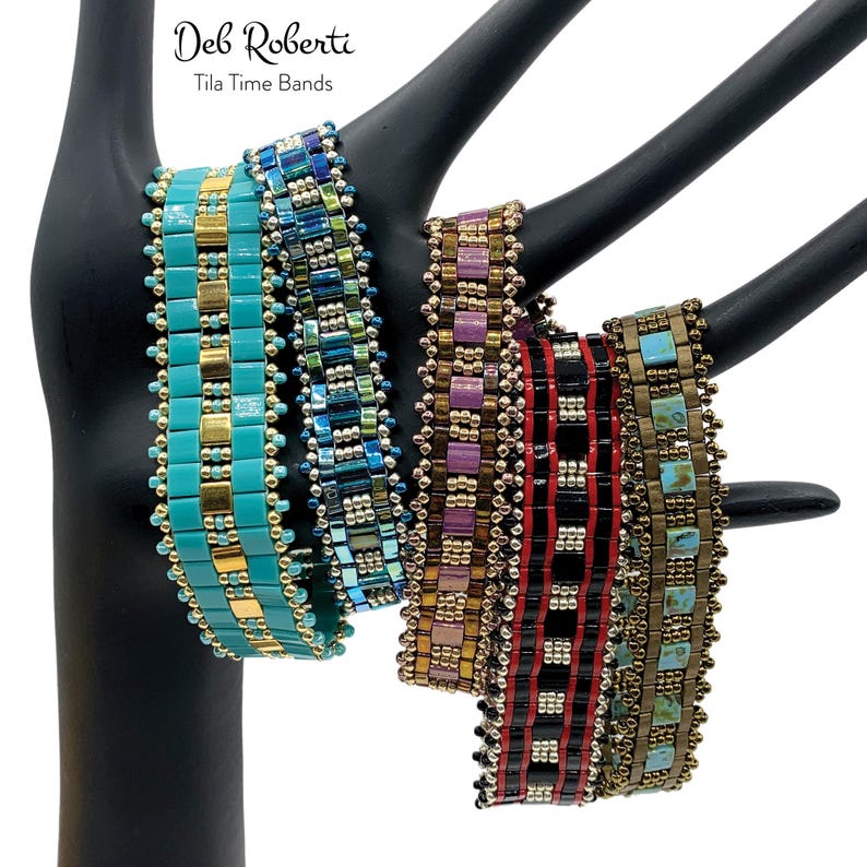 May include: Four beaded bracelets in various colors and patterns, including turquoise, purple, red, and brown. The bracelets are made with small, square beads and are displayed on a black mannequin hand. The text "Deb Roberti Tila Time Bands" is visible above the bracelets.