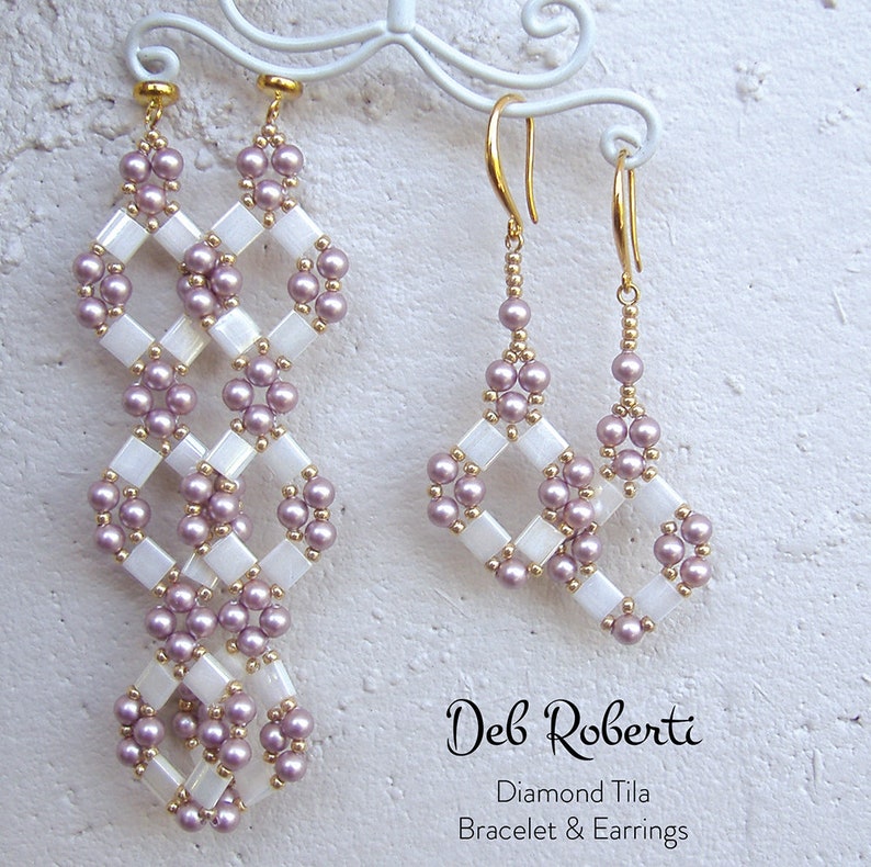 May include: A pair of long, white and purple beaded earrings with a diamond shape design. A smaller pair of earrings with the same design are also shown. The earrings are labeled "Diamond Tila Bracelet & Earrings" by "Deb Roberti".