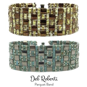 May include: Two beaded bracelets with a geometric pattern. The top bracelet is brown and white, and the bottom bracelet is turquoise and silver. The bracelets are labeled "Deb Roberti Parquet Band".