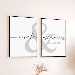 May include: Two black framed prints with white backgrounds and gray ampersand symbols. The left print says "meals" and the right print says "memories are made here".