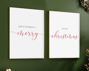 May include: Two rectangular wall art prints in thin gold frames with white backgrounds. The left print features the black text HAVE YOURSELF A and the red cursive text merry. The right print features the black text LITTLE and the red cursive text christmas.