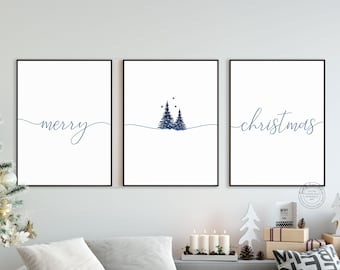 May include: A set of three framed wall art prints with black frames. The left print features the word merry in blue cursive script. The center print shows two blue pine trees. The right print features the word christmas in blue cursive script.