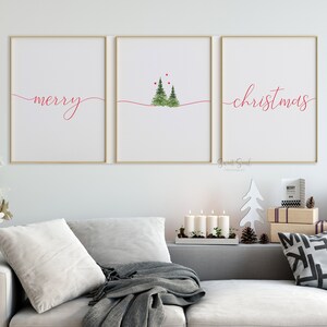 May include: Three framed prints with a white background and red text. The left print says "merry" in cursive. The middle print has a simple illustration of three green trees with red dots above them. The right print says "christmas" in cursive.