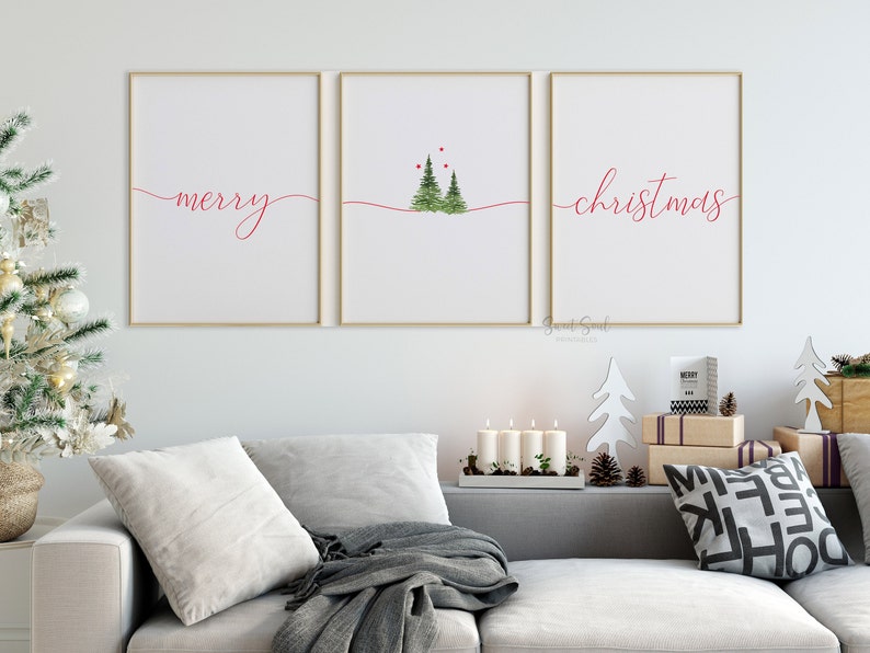May include: Three framed prints with a white background and red text. The left print says "merry" in cursive. The middle print has a simple illustration of three green trees with red dots above them. The right print says "christmas" in cursive.