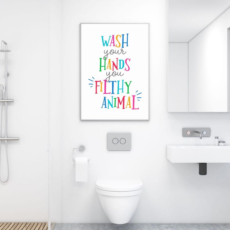 May include: A rectangular wall art print featuring the text WASH your HANDS you FILTHY ANIMAL in colorful, multi-colored lettering. The words are stacked vertically with a playful font style, set against a plain white background.
