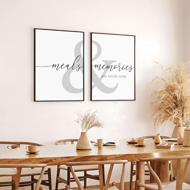 May include: Two black framed prints with white backgrounds and gray ampersand symbols. The left print says "meals" and the right print says "memories are made here".