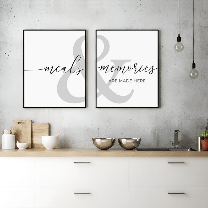 May include: Two black framed prints with white backgrounds and gray ampersands. The left print says "meals" and the right print says "memories are made here".