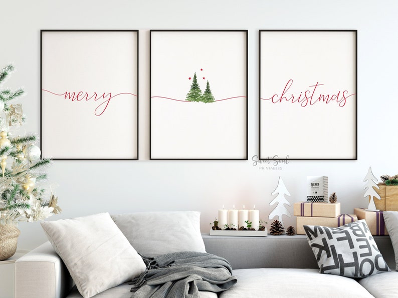 May include: Three framed prints with a white background and red cursive text. The left print says "merry", the middle print has two green watercolor trees with red dots, and the right print says "christmas".