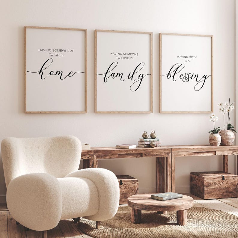 May include: Three framed prints with white backgrounds and black text. The first print says "Having somewhere to go is home". The second print says "Having someone to love is family". The third print says "Having both is a blessing".