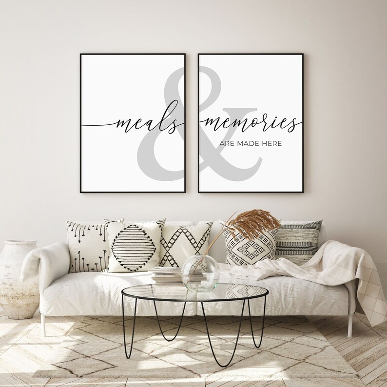 May include: Two black framed prints with a gray ampersand symbol and the text "meals & memories are made here" in black cursive font.