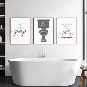 May include: Three framed wall art prints with white backgrounds and dark gray text. The left print reads Have a nice poop, the center print shows a toilet silhouette with the text Shit is about to go down, and the right print reads Wash your hands you filthy animal.