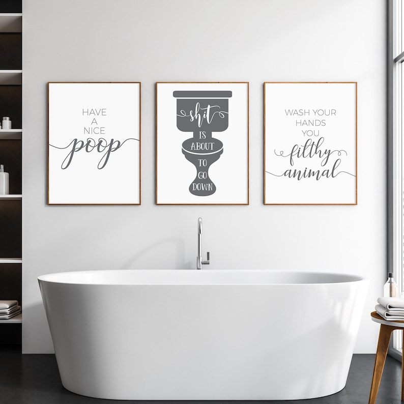 May include: Three framed wall art prints with white backgrounds and dark gray text. The left print reads Have a nice poop, the center print shows a toilet silhouette with the text Shit is about to go down, and the right print reads Wash your hands you filthy animal.