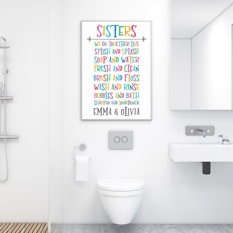 May include: A colorful bathroom sign with the text "SISTERS" and a list of activities, including "Splish and Splash", "Soap and Water", "Fresh and Clean", "Brush and Floss", "Wash and Rinse", "Bubbles and Bath", "Shampoo and Conditioner", and "Emma & Olivia".