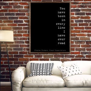 May include: Black and white typography quote on a framed canvas with a white background. The quote reads "You have been in every line I have ever read."  The quote is attributed to Charles Dickens, Great Expectations.