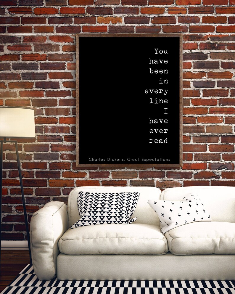 May include: Black and white typography quote on a framed canvas with a white background. The quote reads "You have been in every line I have ever read."  The quote is attributed to Charles Dickens, Great Expectations.