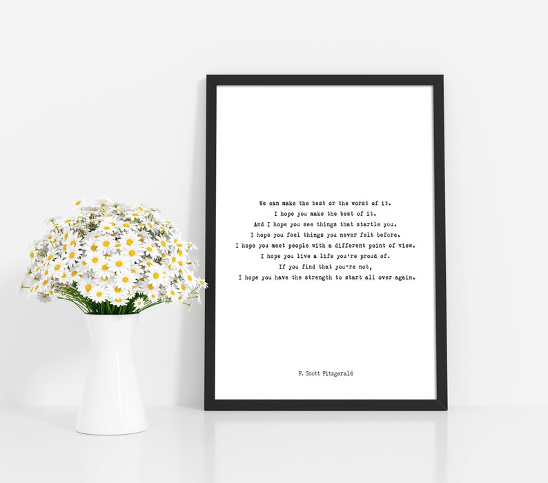 May include: A black framed wall art print featuring a F. Scott Fitzgerald quote in a typewriter-style font on a white background. The text reads: We can make the best or the worst of it. I hope you make the best of it. I hope you have the strength.