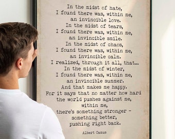 May include: A framed print with a beige background and black text. The text is a quote by Albert Camus about finding strength within oneself. The quote reads: "In the midst of hate, I found there was, within me, an invincible love. In the midst of tears, I found there was, within me, an invincible smile. In the midst of chaos, I found there was, within me, an invincible calm. I realized, through it all, that... In the midst of winter, I found there was, within me, an invincible summer. And that makes me happy. For it says that no matter how hard the world pushes against me, within me, there's something stronger - something better, pushing right back. - Albert Camus"