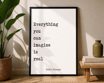 May include: A rectangular framed wall art piece featuring a white background with black typewriter-style text that reads: Everything you can imagine is real. The name Pablo Picasso is printed in smaller black text at the bottom of the print.
