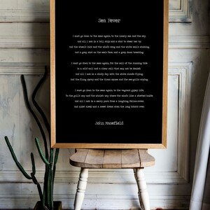 May include: A framed black and white print of the poem "Sea Fever" by John Masefield. The poem is printed in a typewriter font and the background is black.
