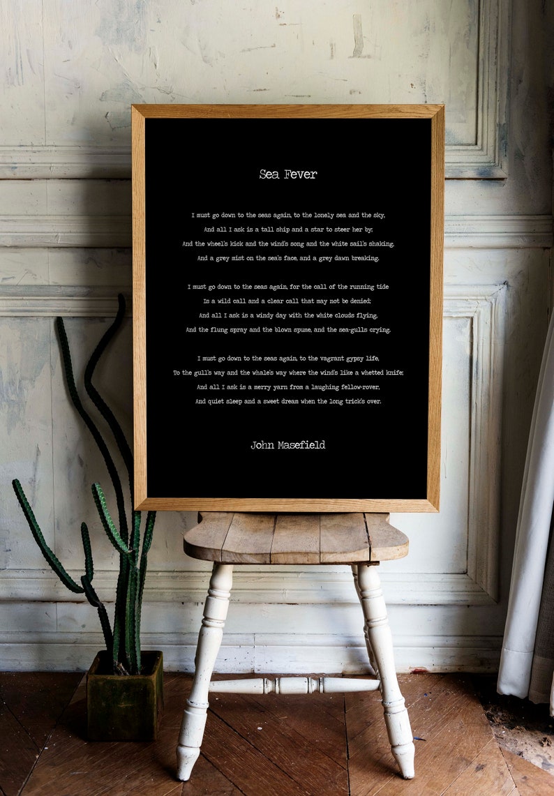 May include: A framed black and white print of the poem "Sea Fever" by John Masefield. The poem is printed in a typewriter font and the background is black.