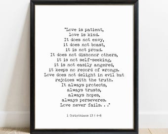 May include: A framed wall art print featuring black typewriter-style text on a white background. The text reads: Love is patient, love is kind. It does not envy, it does not boast, it is not proud. It does not dishonor others, it is not self-seeking, it is not easily angered, it keeps no record of wrongs. Love does not delight in evil but rejoices with the truth. It always protects, always trusts, always hopes, always perseveres. Love never fails... 1 Corinthians 13 : 4-8.