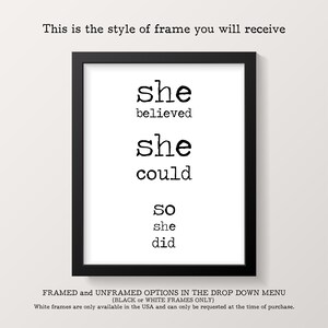 May include: A black framed print with the text "she believed she could so she did" in a typewriter font.