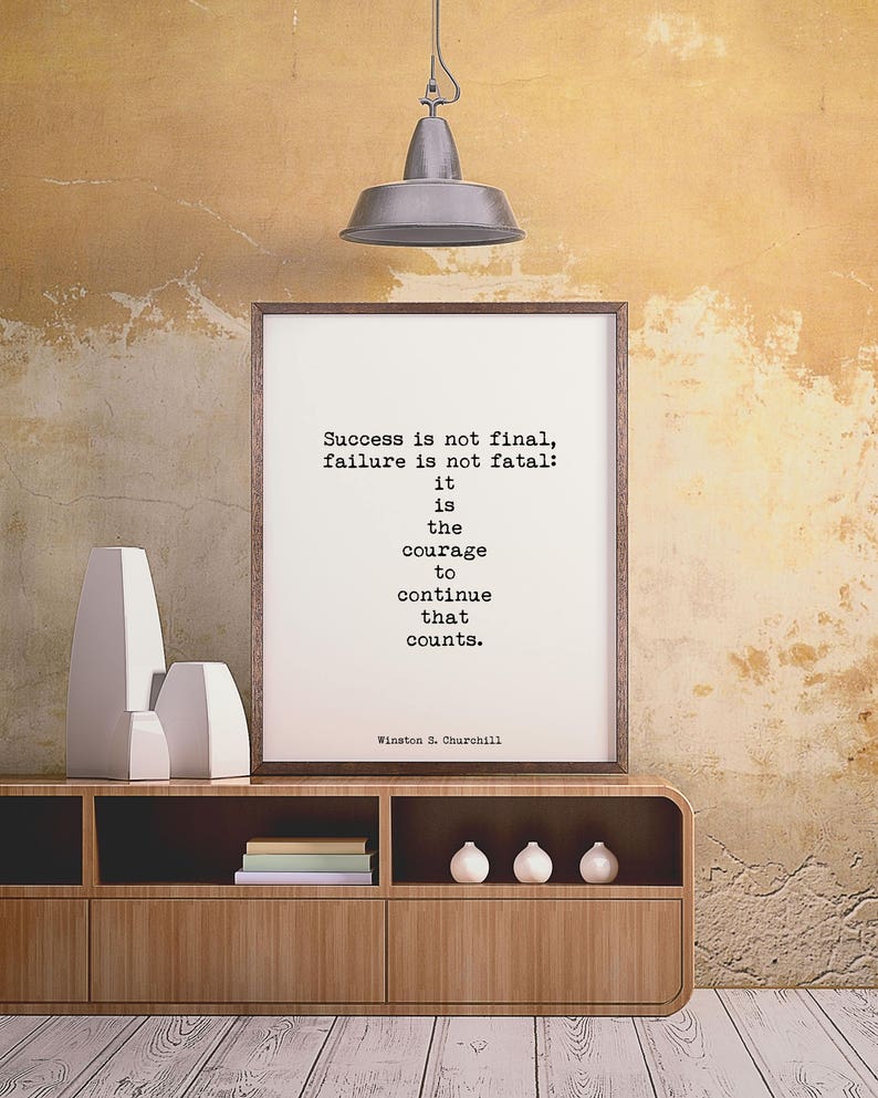 May include: A framed print with a motivational quote by Winston S. Churchill: "Success is not final, failure is not fatal: it is the courage to continue that counts."