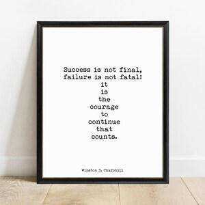May include: A framed wall art print featuring black typewriter-style text on a white background. The quote reads: Success is not final, failure is not fatal: it is the courage to continue that counts. Winston S. Churchill is signed at the bottom.