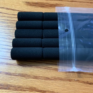 May include: A package of six black foam pipe insulation sleeves. The sleeves are in a clear plastic bag with a zipper closure.