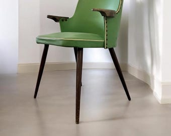 May include: A mid-century modern chair with a green seat and back, accented with a white trim. The chair has dark wooden legs and armrests. The chair is a stylish piece of furniture.