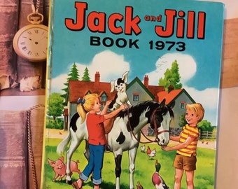 May include: A vintage children's book titled "Jack and Jill Book 1973" with a blue cover featuring illustrations of a girl riding a horse, a boy, a dog, and farm animals. The book is a Fleetway Annual.