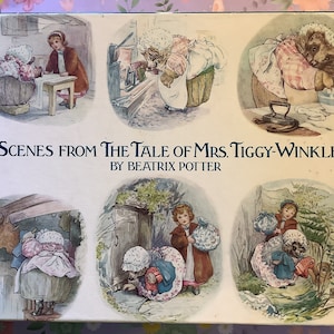May include: A vintage box featuring six illustrated scenes from "The Tale of Mrs. Tiggy-Winkle" by Beatrix Potter. The box is cream-colored with blue text and a light blue border.