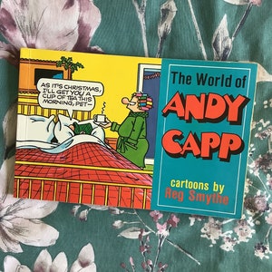May include: A vintage comic book cover featuring a cartoon illustration of a man and woman in a bedroom setting. The cover text reads "The World of Andy Capp cartoons by Reg Smythe".