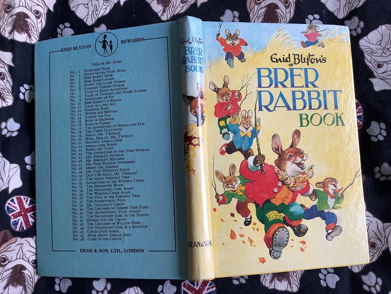May include: Open vintage children's book titled "Brer Rabbit Book" by Enid Blyton. The cover features illustrations of rabbits in colorful clothing. The book is open, revealing a list of stories and the title page.