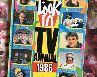 May include: A yellow, blue and red book cover with the title "Look-In TV Annual 1986". The cover features a collage of images of popular TV personalities from the 1980s, including Mr. T, a young woman with a yellow swimming cap, and a man in a motorcycle helmet.